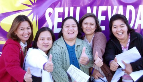 Filipina nurses put their thumbs up after dropping their strike ballots in the box.