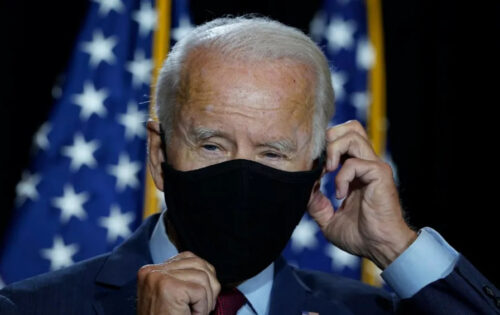 Democratic presidential nominee Joe Biden puts his mask back on after delivering remarks in Wilmington, Delaware on August 13, 2020. (Drew Angerer / Getty Images)